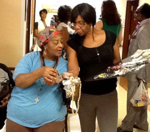 Resident picking out jewelry at the Jewels for Jewels party at A.G. Rhodes