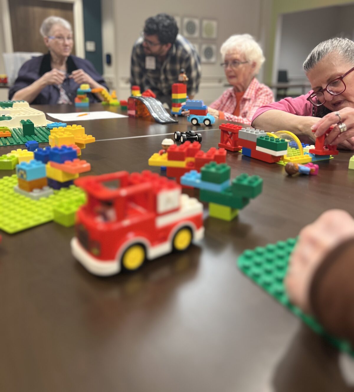 Volunteer Shows Elders How to LEGO and Have a Good Time